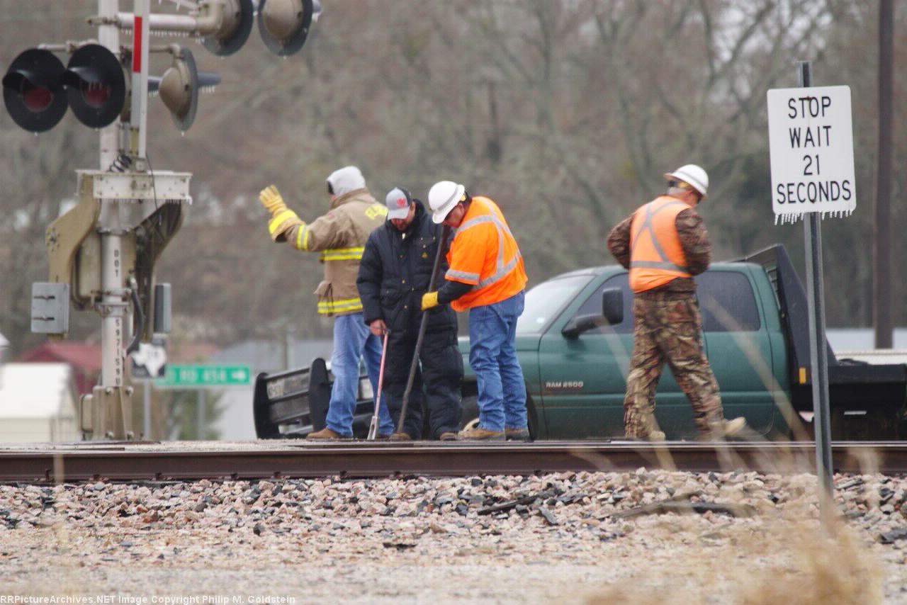 Track supervisor, track inspector and a couple of the VFD prying a crossing panel to clear the flangeway